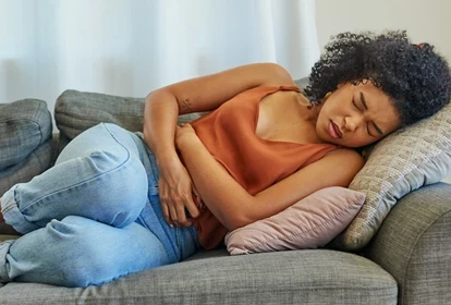 a lady on the couch with bowel discomfort